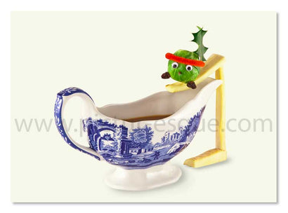 Humorous Christmas card featuring a dressed up sprout preparing to slide into a gravy boat